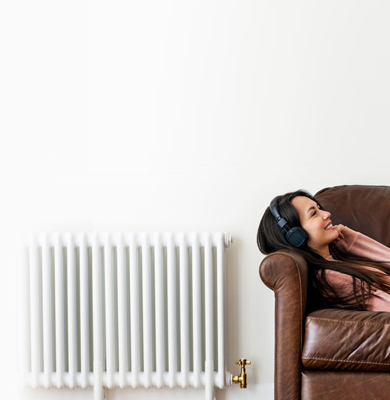 Woman reclines on her sofa while engaged in a phone conversation