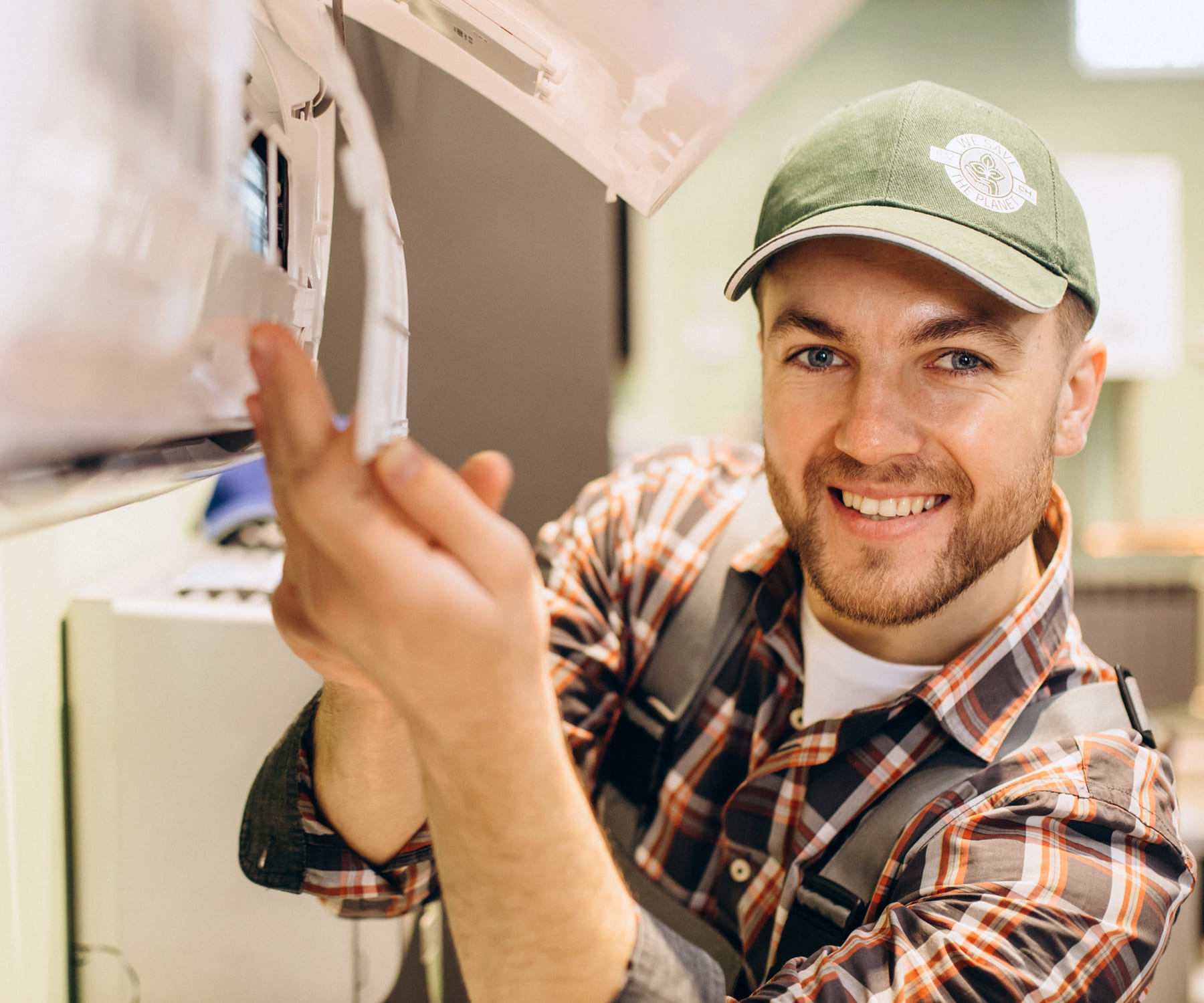 smiling technician fixing a AC unit