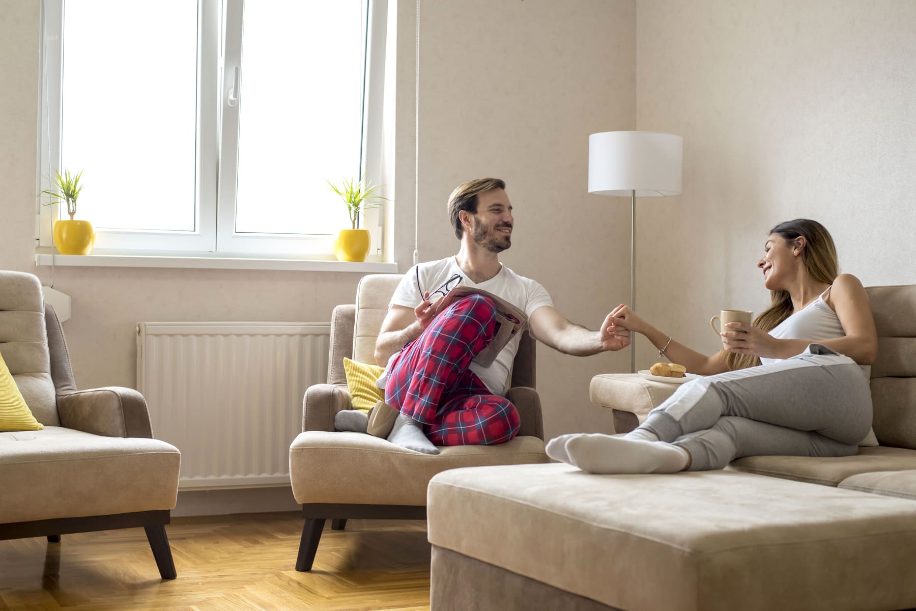 Couple in living-room with radiator on the wall