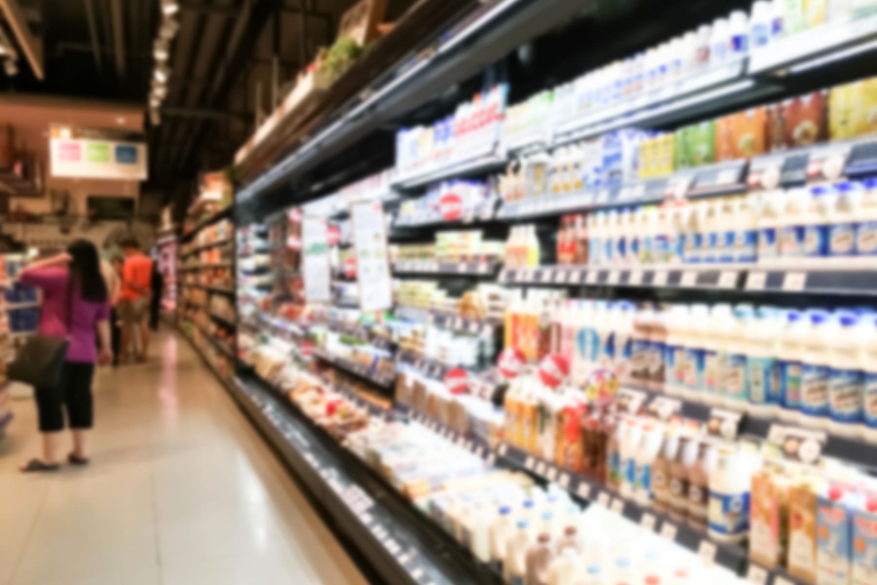 long refrigerator with food in supermarket
